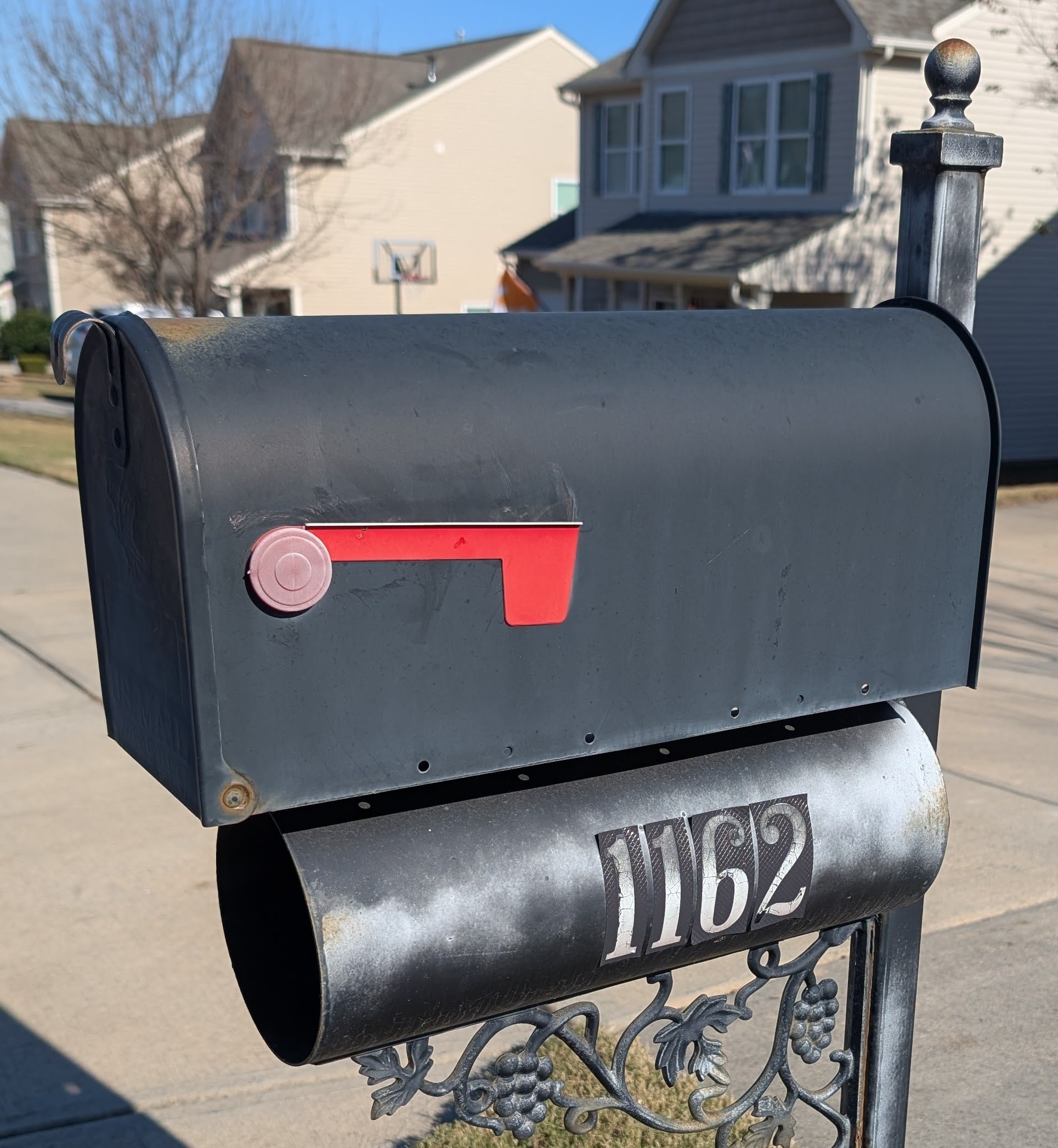Weathered rusty mailbox with peeling paint and crooked post before mailbox refresh service in Indian Land South Carolina